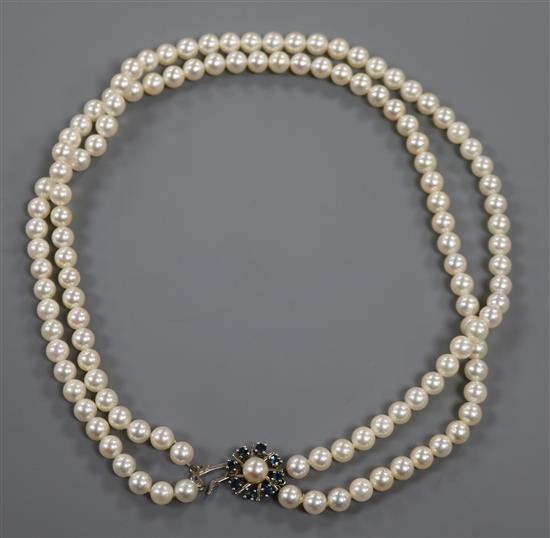 A double strand cultured pearl necklace with 14ct sapphire and cultured pearl set clasp, 42cm.